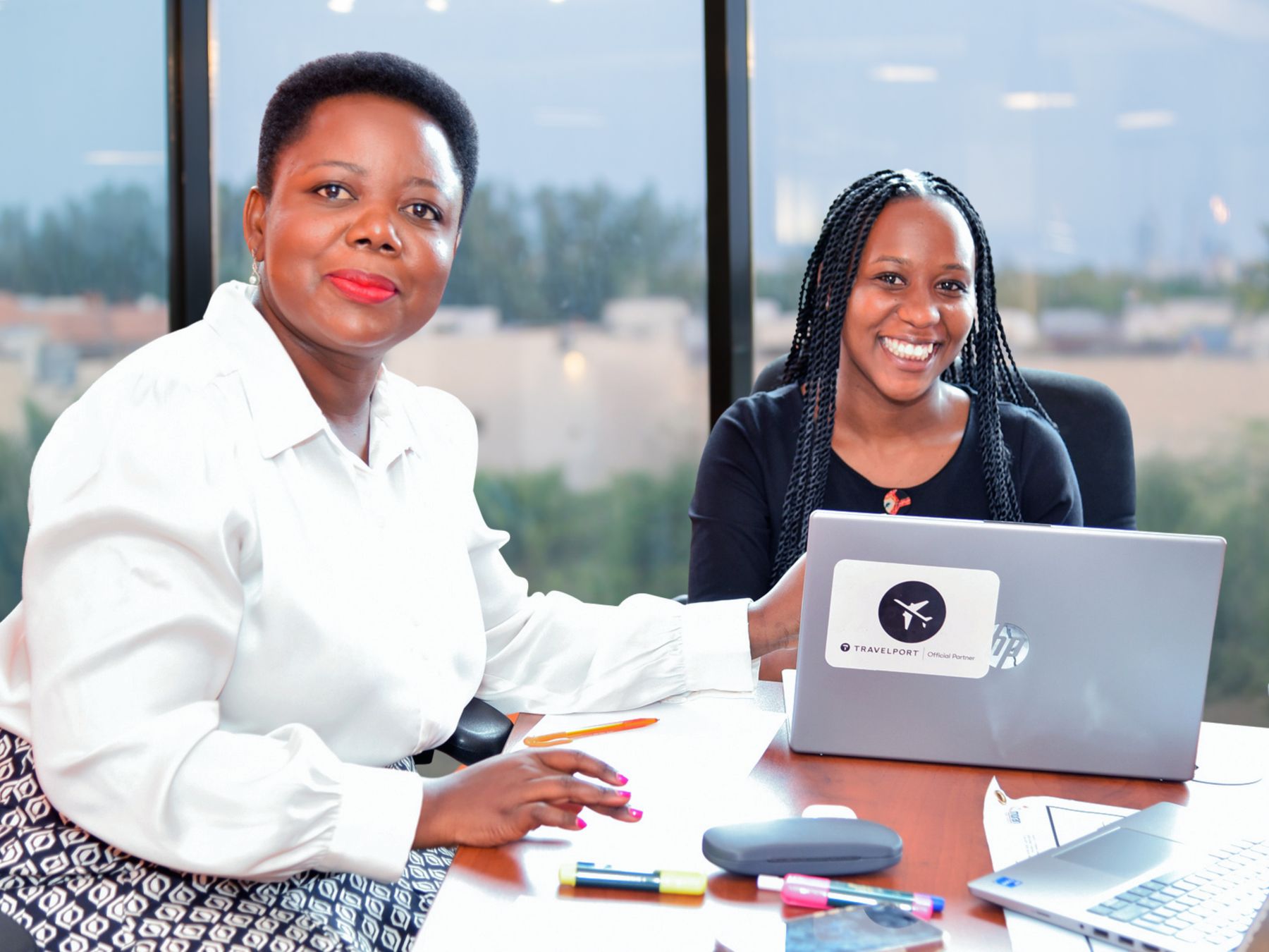 Evelyn Sylvia Nakazi at her desk with a colleague
