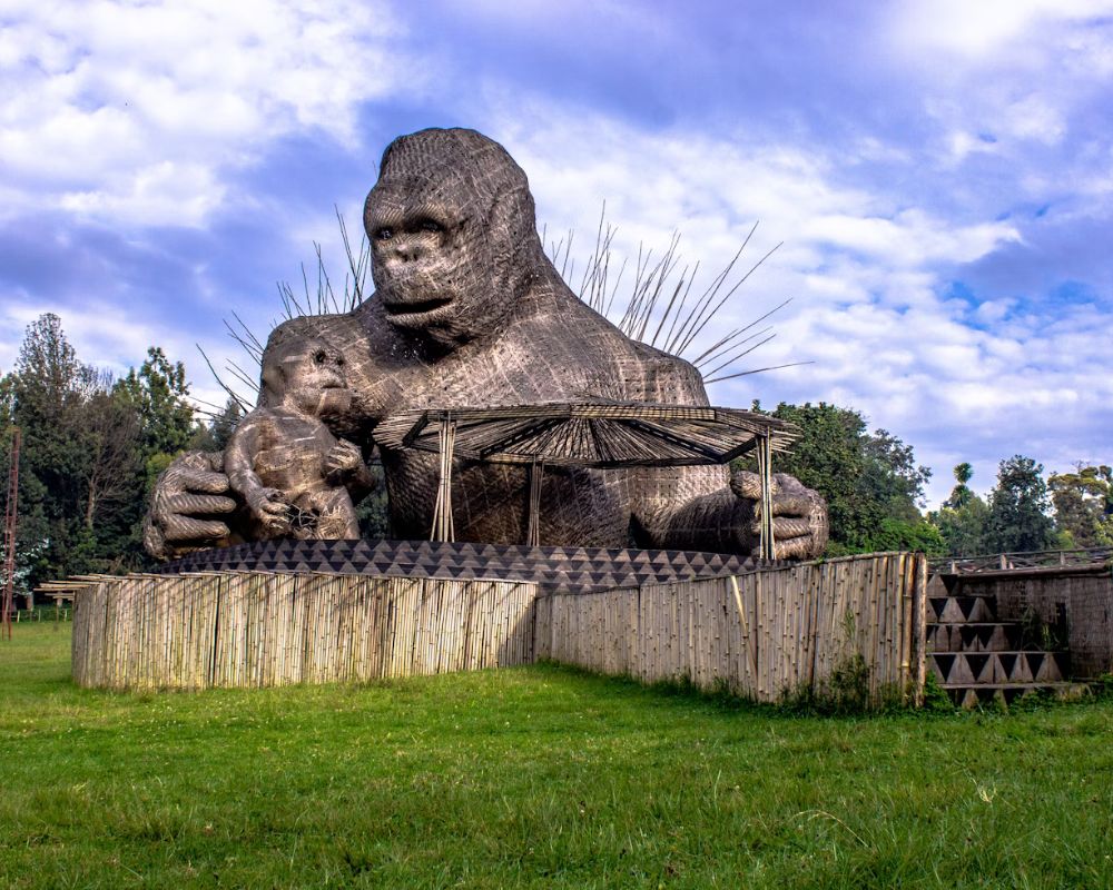 A large gorilla sculpture under a blue sky in Rwanda